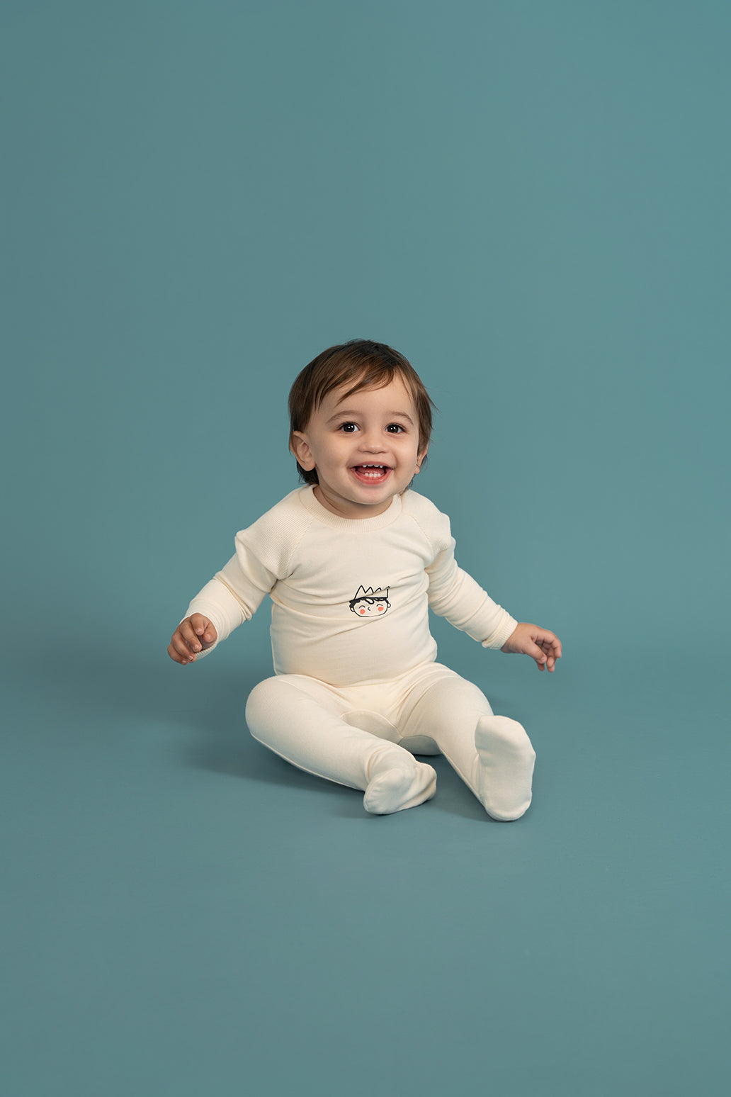 Crown Print Onesie in by Charlotte & George